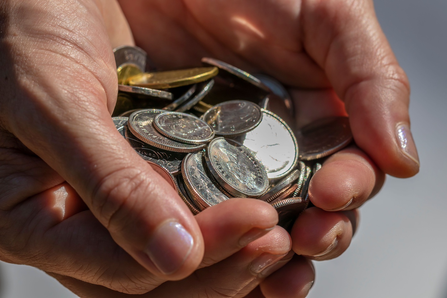 CloseupTwoHandsCoins