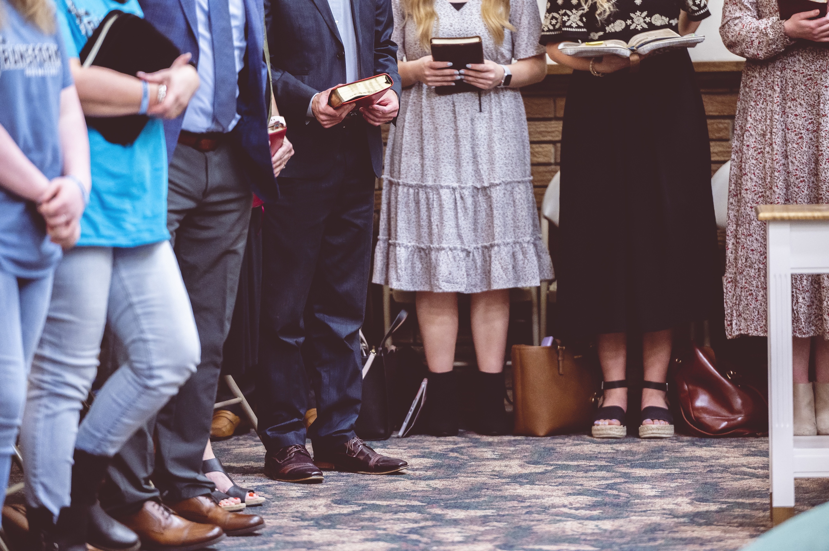 group of people holding bible books group of people holding bible books