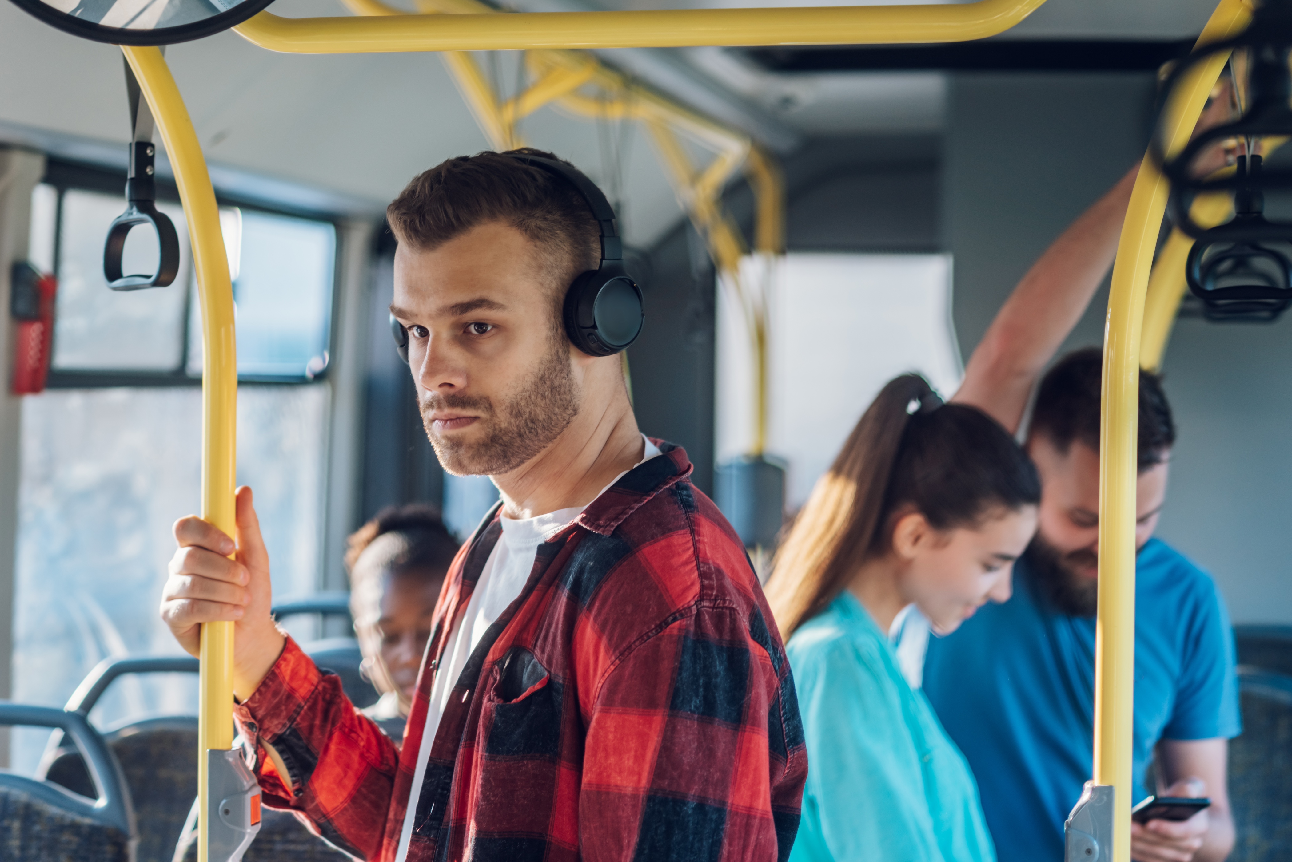 Man riding a bus wearing headphones