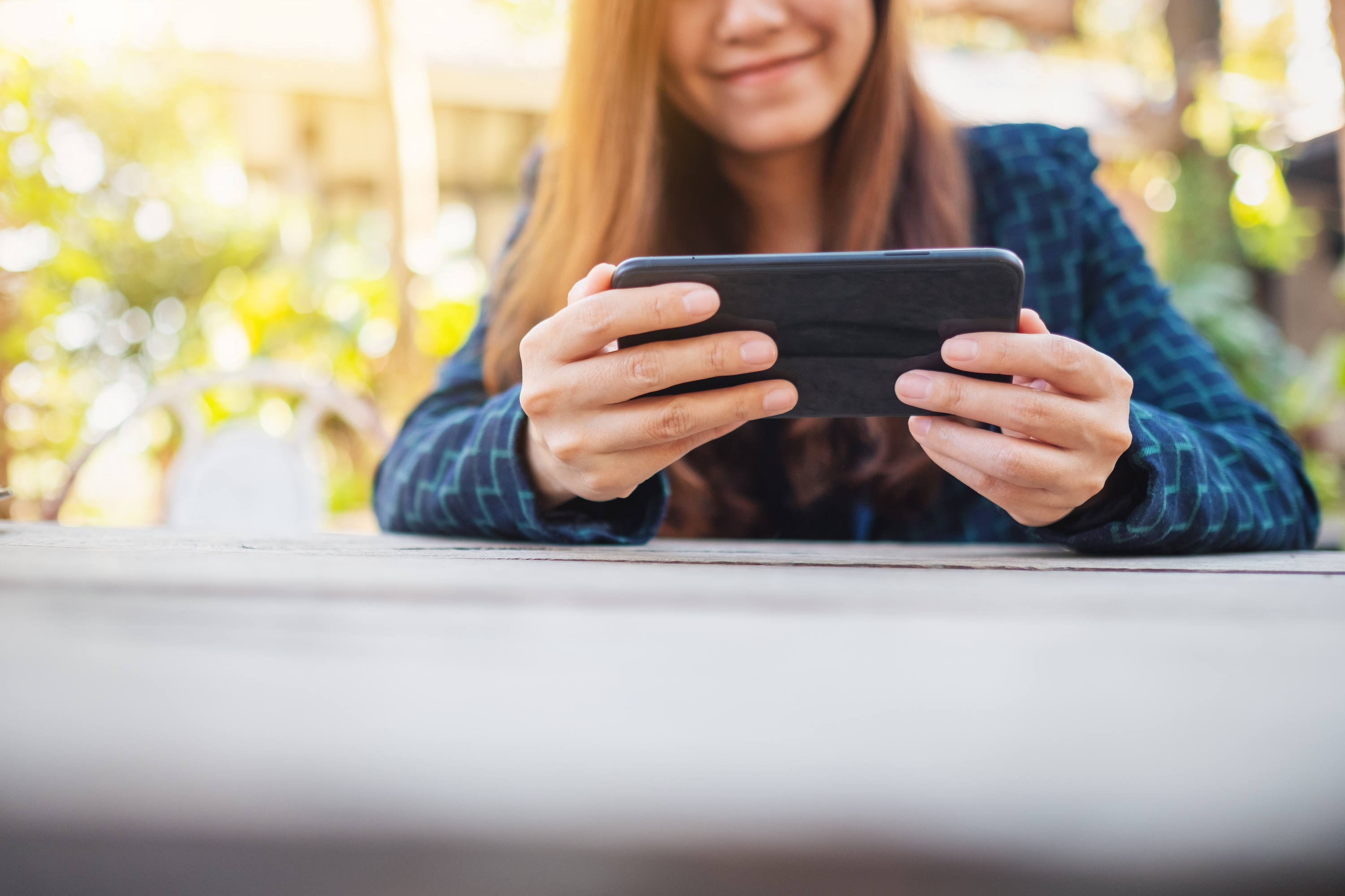 WomanPlaying computer game on phone